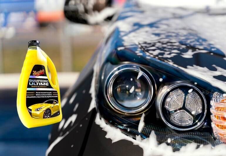 Une femme lave sa voiture à l'extérieur